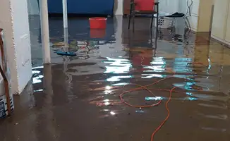 Basement with boiler, cabinets and washing machine completely flooded in Lowell, MA