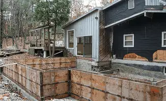 Prepared site with foundation forms for home remodeling and addition project in Lowell, MA